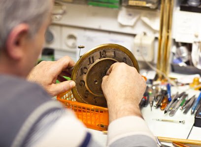 Clockmaker in his workshop repairing